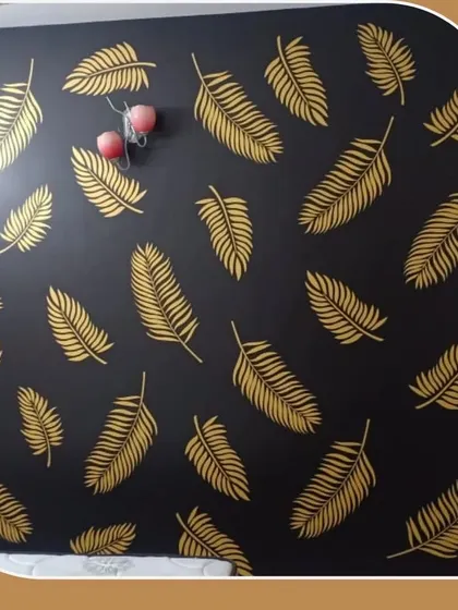 A bold and glamorous accent wall featuring golden leaves on a black background. This design is perfect for adding a touch of luxury and drama.