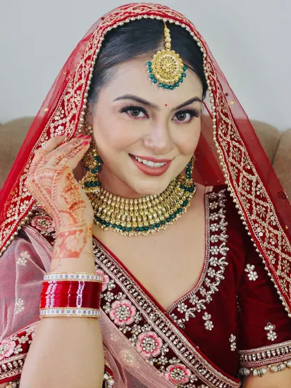 A happy, smiling portrait of the bride, looking directly at the camera.