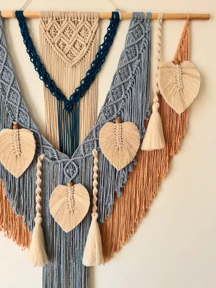 A side view showing the layering of colors and textures in this large, custom macrame piece.