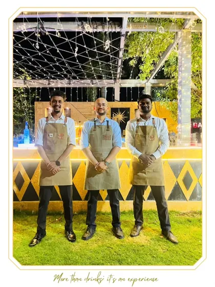 Three of our expert bartenders in uniform, ready to elevate a celebration with impeccable service.