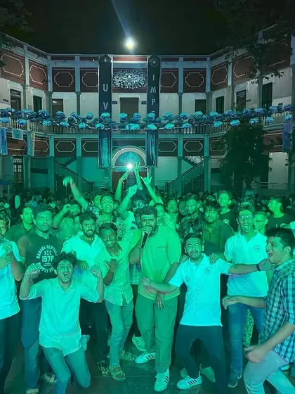Another shot of the UVCE crowd under green lights, showing the vibrant lighting production we set up for the event.