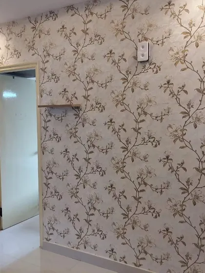 A hallway with a delicate floral vine wallpaper, adding elegance and a welcoming feel to the home.