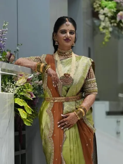 A close-up of the client's beautiful smile and her stunning ensemble. The custom-designed blouse is a true work of art.