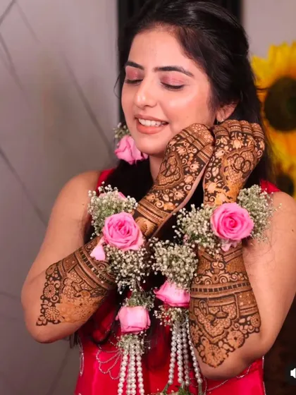 A beautiful shot of a bride with floral jewelry that perfectly complements her fresh henna. It's always a joy to see my work as part of the complete bridal ensemble.