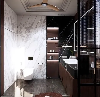 This view shows the contrast between the dark and light marble used in the washroom. The design includes built-in, back-lit shelves that provide both storage and soft, ambient lighting.