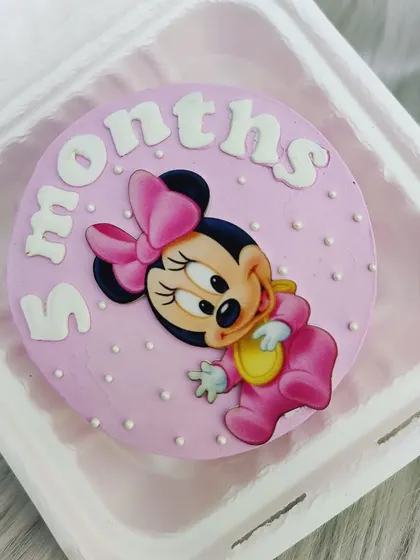 A cute Minnie Mouse bento cake for a 5-month celebration. It's a lovely way to mark the halfway point to their first birthday.
