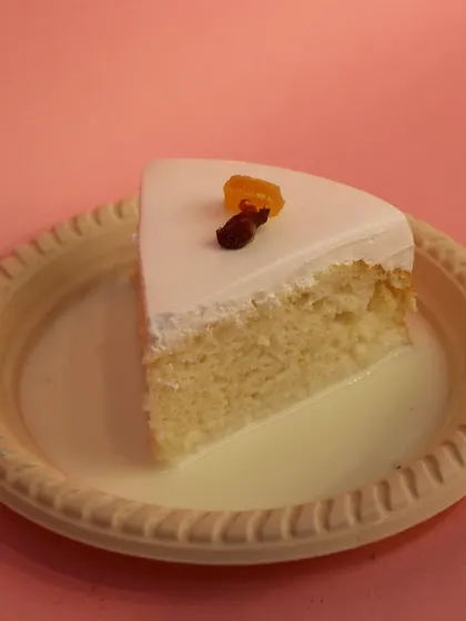 A clean, simple shot of our eggless Milk Pastry, highlighting its soft texture and the pool of sweet milk it sits in.