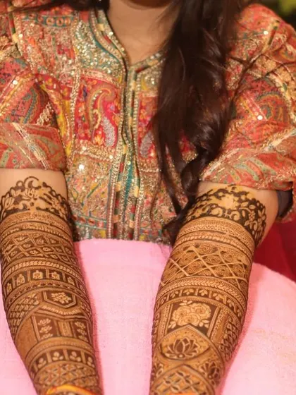 This photo shows the full length of a bridal mehandi design, covering the arms up to the elbows with traditional patterns.