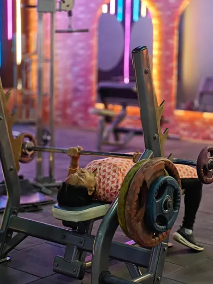 A client pushes through a set on the bench press. We create an environment where every person, regardless of their fitness level, can train hard and feel accomplished.