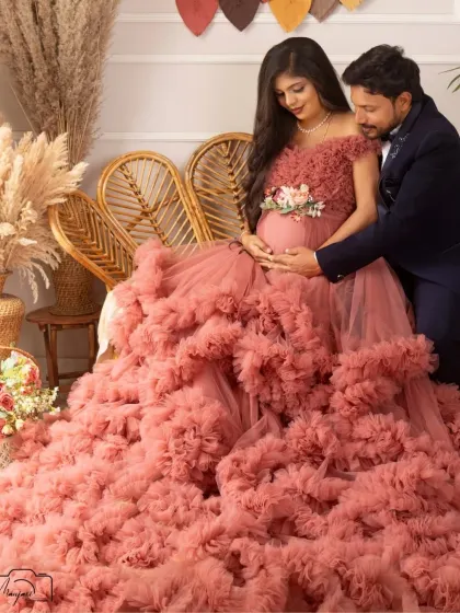 A tender moment between the couple in the boho corner. The way he looks at her and the baby bump is filled with so much love and admiration.