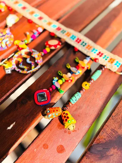 A sunny shot of the 'Rang-Tarang' toran. This piece is a vibrant mix of everything I love: ghungroos, bells, parrots, peacocks, and beads of all kinds.
