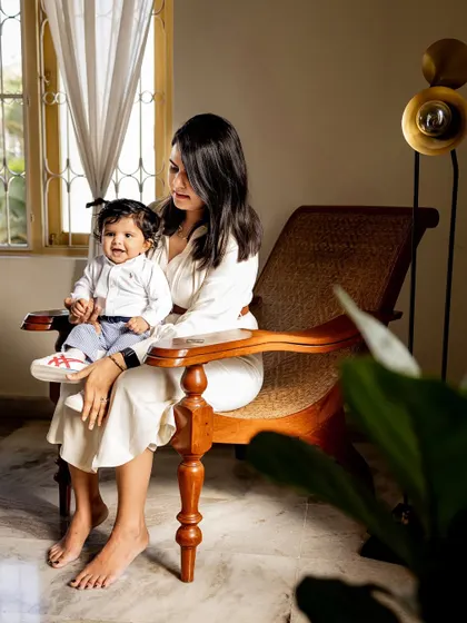 A mother and her baby sharing a happy moment in a classic wooden chair. I love finding unique spots in your home that make for beautiful portraits.