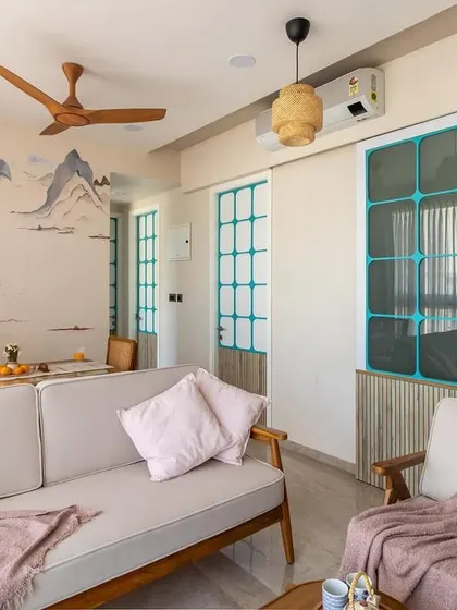 This wide shot captures the serene atmosphere of the living area, where the custom mural provides a stunning focal point that complements the minimalist wooden furniture.