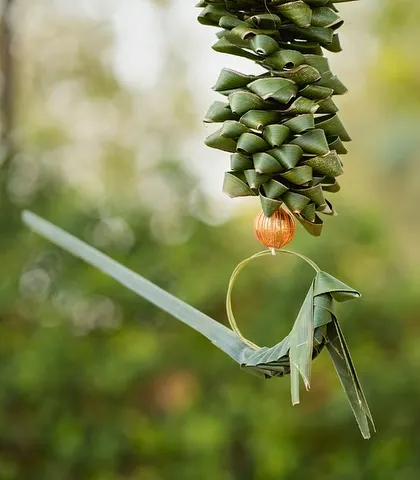 A handcrafted bird made from palm leaves, a beautiful and sustainable decor detail.