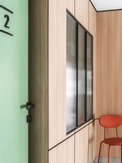 Simple, clear signage is integrated into the design. The number '2' on the door is an example of the functional environmental graphics used for easy wayfinding throughout the clinic.