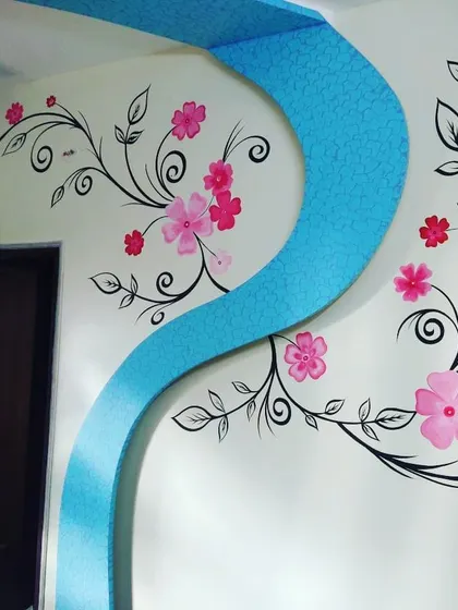 A beautiful hand-painted floral vine mural flows across the wall and onto a textured archway. This project combines our artistic mural services with textured painting for a fully integrated design.