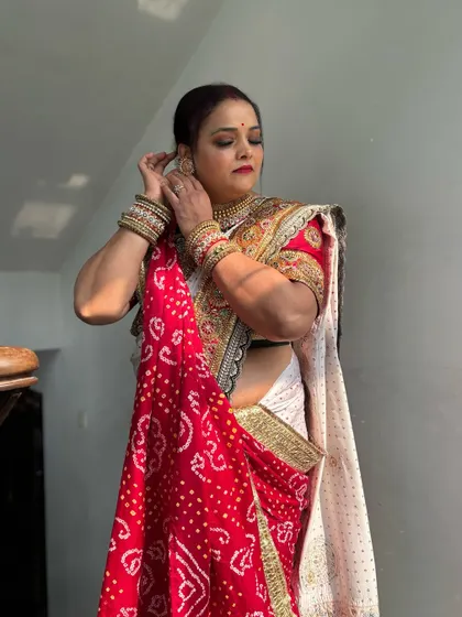 The bride getting ready for her big day. A full-length shot showing her beautiful saree and the classic, elegant makeup and hair I created for her.