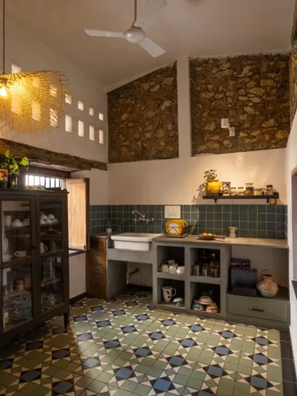 The pantry in our studio. We kept the exposed stone walls and paired them with a custom concrete countertop and beautiful handmade floor tiles. The space is rustic, functional, and full of the building's original character.