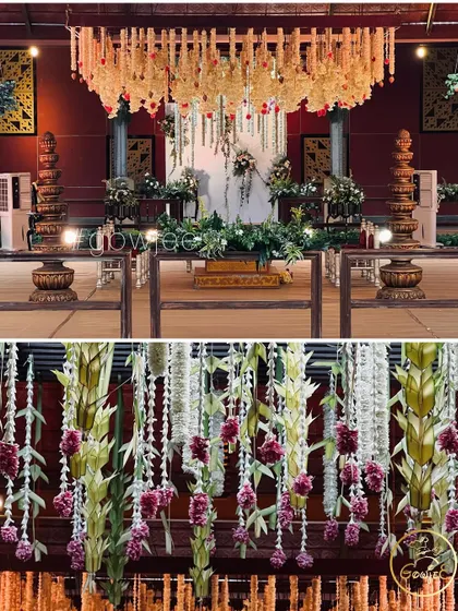 A detailed look at the hanging floral decor inside the wedding hall, combining different types of flowers and leaves.