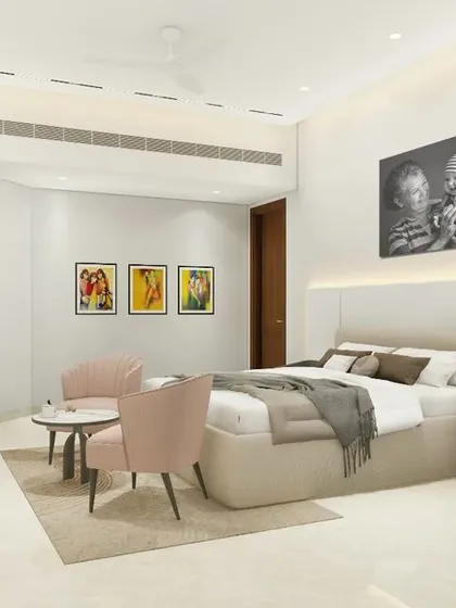 This spacious bedroom in a Gurugram penthouse is designed as a personal haven. It features a comfortable seating nook, soft accent lighting behind the headboard, and an easel for artistic pursuits, blending luxury with individual passions.