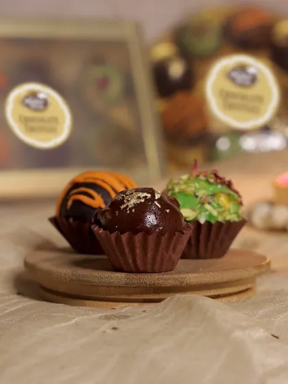 The hazelnut truffle, a classic favorite, is topped with a sprinkle of gold leaf for a touch of luxury. All our truffles are handcrafted to perfection.