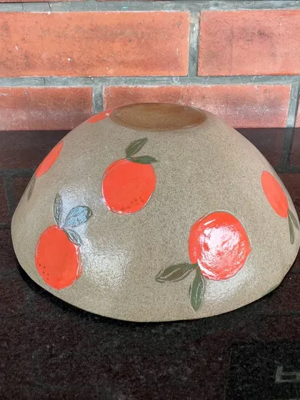 This bright and cheerful bowl with hand-painted oranges was made by a student in my 15-day combined workshop. It shows a wonderful use of underglaze colors on a hand-built form.