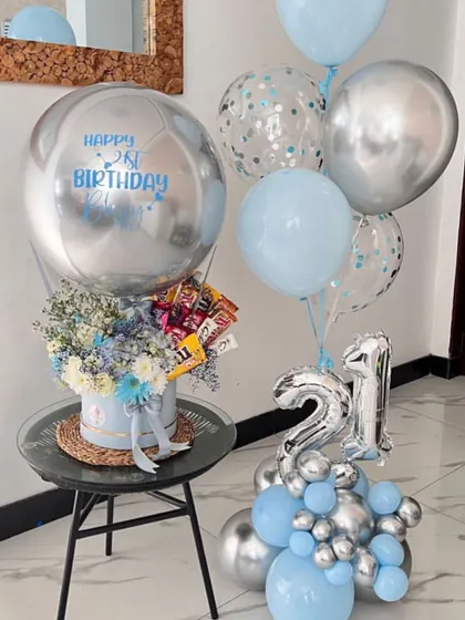 Celebrating a 21st birthday with a cool blue and silver theme. This hamper includes a box of flowers and chocolates, topped with a personalized orbz balloon and a matching balloon bunch.
