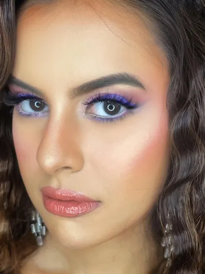 A beautiful evening glam look with a pop of blue and pink. The close-up shot shows the importance of detailing and blending for a seamless finish.