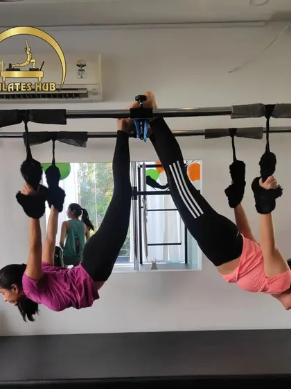 Two clients perform a synchronized inversion on the Cadillac, a beautiful display of strength and teamwork.