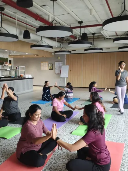 A moment of connection and fun during a partner yoga session, fostering teamwork and positive interaction.