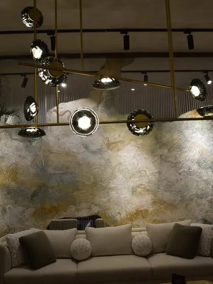 Another shot of the India Art Fair VIP lounge, showing the Ross Gardam Ceto chandelier against a textured wall. My goal was to create a space where lighting and art are in constant dialogue.