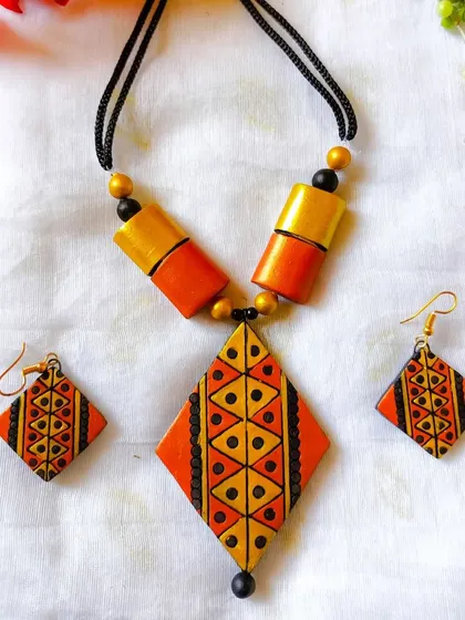 The same diamond-pendant set in a rustic orange and gold combination.