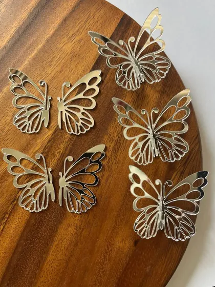 Delicate silver mirror acrylic butterflies. These versatile charms can be used to decorate cakes, cupcakes, or any dessert for a touch of magic.