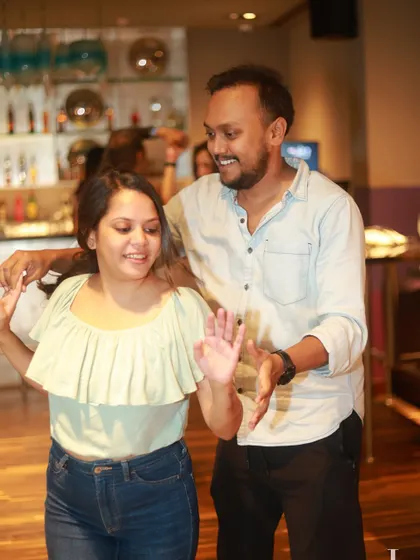 Two dancers smiling and enjoying the rhythm. The casual and friendly atmosphere is perfect for making new friends.