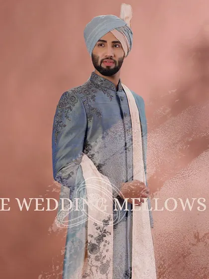 Our sherwani paradise awaits. This dusty blue sherwani with delicate embroidery and a matching stole is a testament to our wide range of choices.