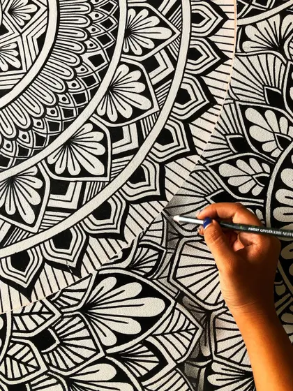 A close up on the details of the layered mandala, showing the clean, crisp lines of the freehand drawing.