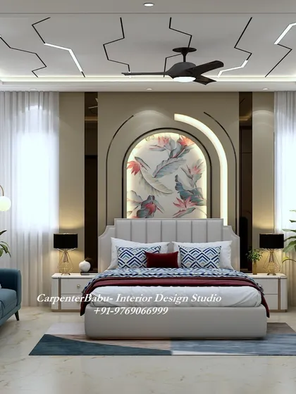 A luxurious master bedroom with a unique false ceiling design that mimics lightning. The headboard wall features a beautiful floral mural within an arched niche.