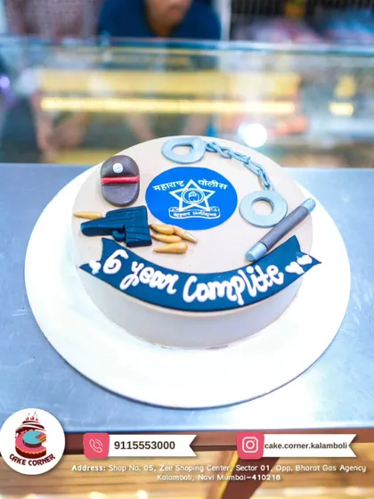 A cake celebrating 6 years of service in the Maharashtra Police. It features the police logo, handcuffs, and a baton, honoring their dedication.