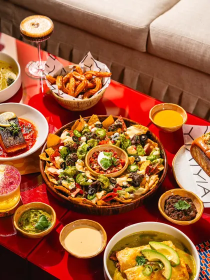 A massive spread of Mexican-inspired dishes at Lyla Bombay. This "table-scape" shot is perfect for showcasing the variety of the menu and encouraging group dining.