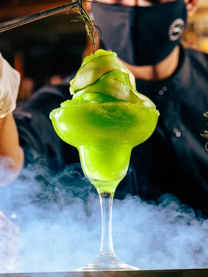 Another look at our signature green frozen margarita, a popular choice from our luncheon and sundowner menu, offering a spirited escape.