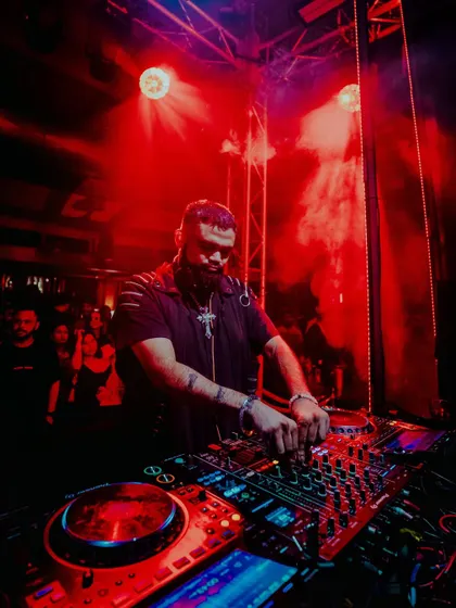 A close-up of me mixing under intense red light at The Kai Room in Gurugram.