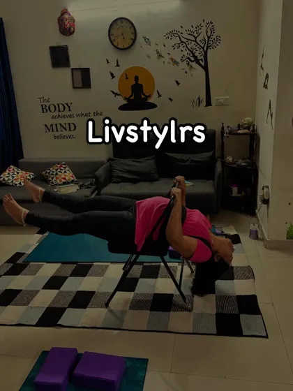 A client in a supported inversion on a yoga chair, a restorative pose that helps to decompress the spine and calm the nervous system.