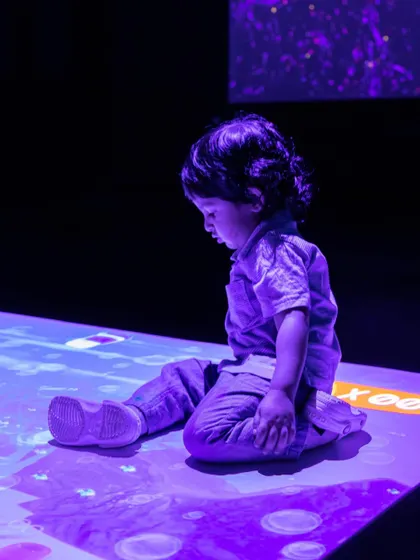 This little one is mesmerized by our interactive, animated floor that reacts to every touch and step.