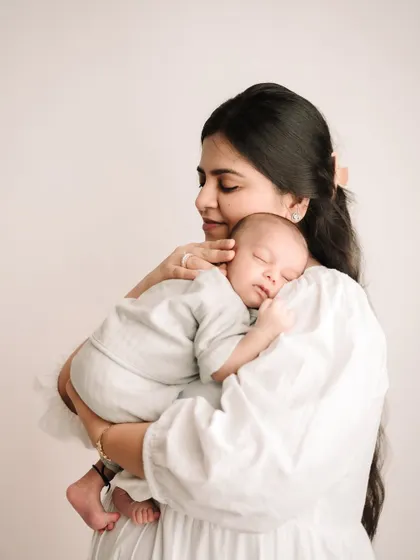 The peaceful, quiet love between a mother and her newborn. My newborn sessions are all about capturing this serene connection in a simple, timeless way.