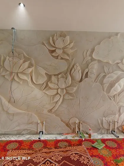 This is a 3D wallpaper that looks like a carved stone mural. The lotus design has depth and texture, creating a serene and artistic feature wall, perfect for a prayer or living room.