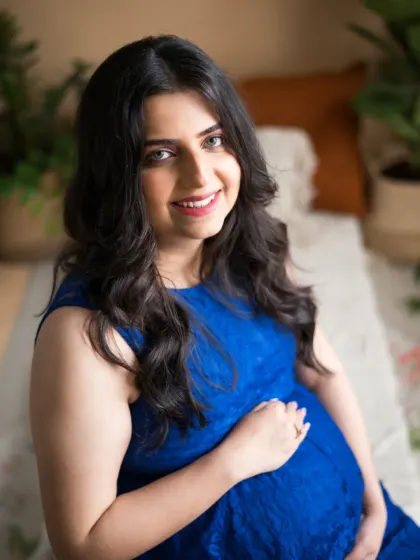 A radiant portrait of the expecting mother, her smile lighting up the frame. This close-up captures the pure joy and excitement of this special time in her life.