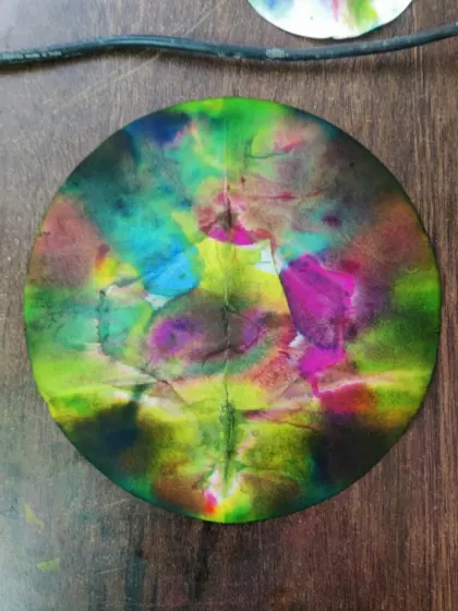 A beautiful chromatography experiment, creating a vibrant, tie-dye like pattern on paper.