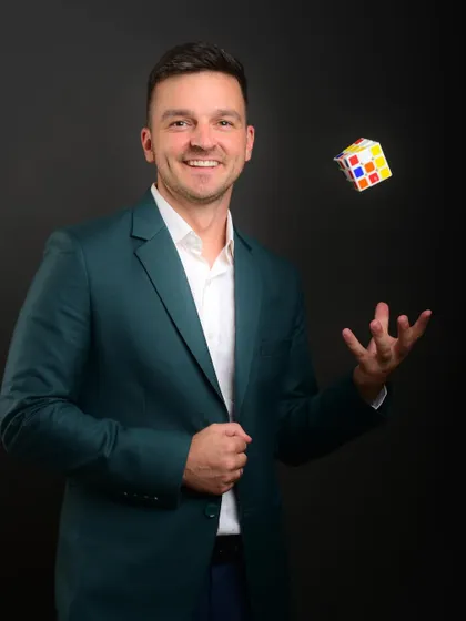 A creative corporate portrait incorporating a prop like a Rubik's cube. This can symbolize problem-solving, creativity, and intelligence, adding a unique layer to a professional's brand.