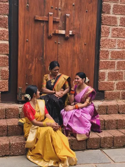 A candid conversation between friends, all dressed in beautiful silk sarees. These are the simple joys of life.