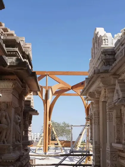The construction of modern timber pavilions at the historic temple site in Palitana, Gujarat. These structures provide shaded gathering spaces for pilgrims, and their innovative wooden forms create a contemporary dialogue with the ancient stone temples.